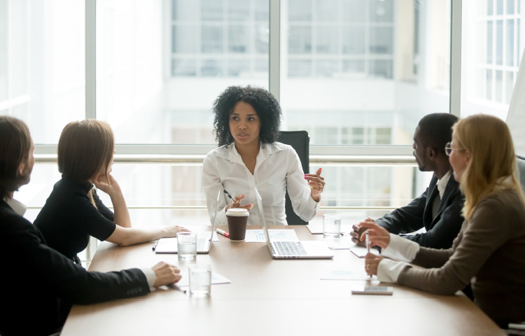 A woman chairs a meeting