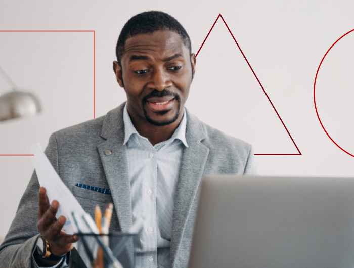 Man in a suit holding a document, discussing its contents.