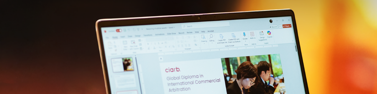 A laptop screen showing a presentation on the Virtual Global Diploma in International Commercial Arbitration