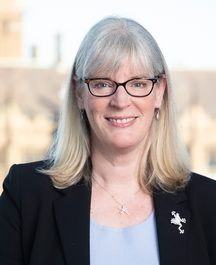 Woman wearing glasses smiling at camera