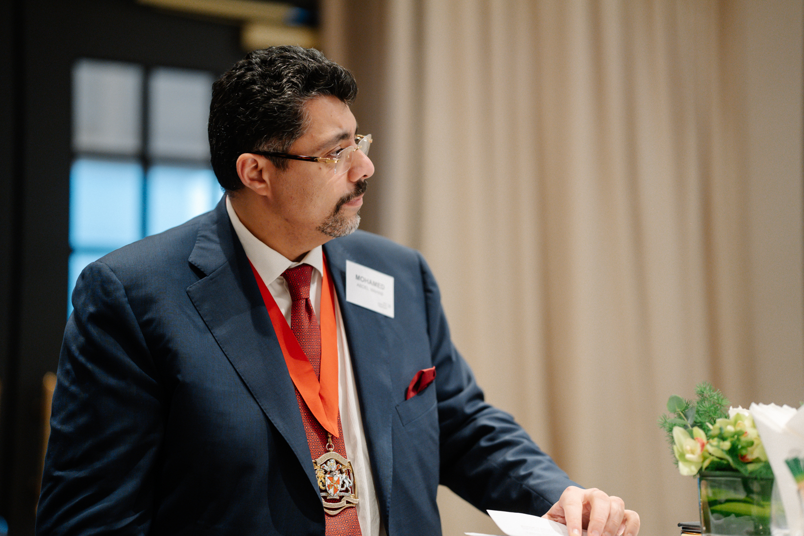 Man wearing suit and glasses